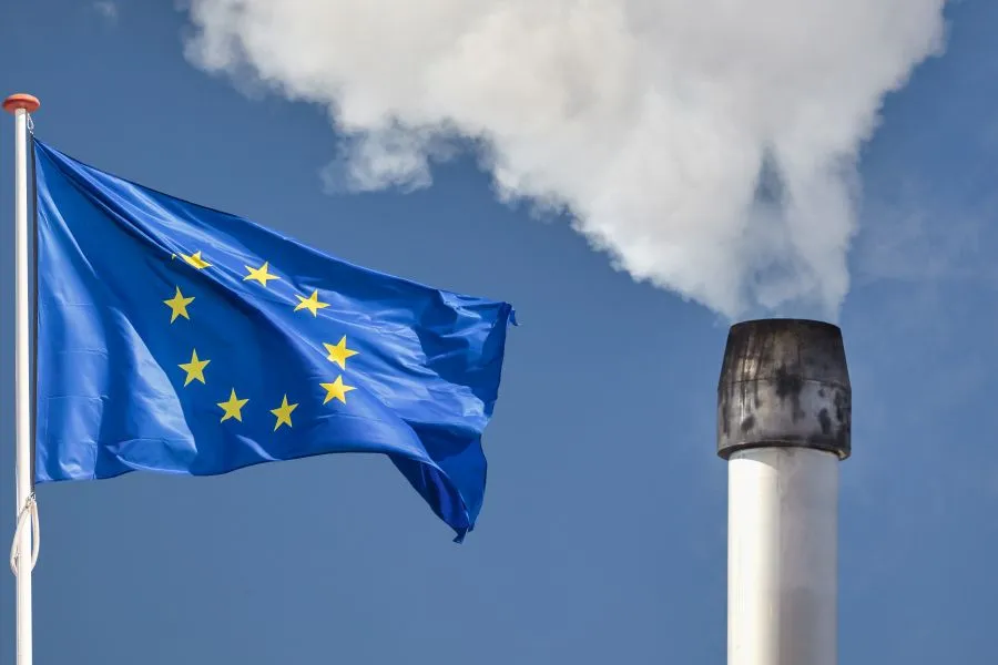 EU flag and chimney pipe with smoke